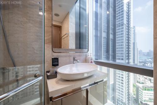 a bathroom with a sink and a large window at Landmark 81 President Suite - Vinhome Central Park in Ho Chi Minh City