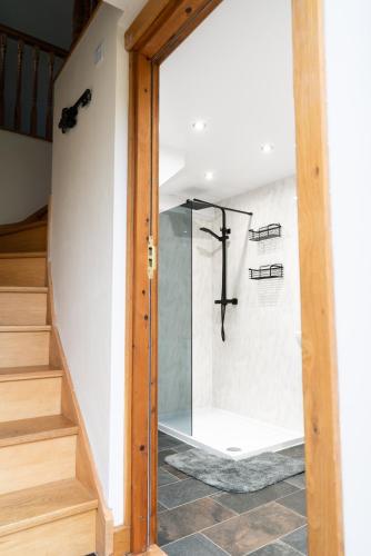 a glass door leading into a bathroom with a shower at Silverwood Loft in Telford