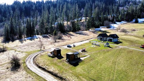 an aerial view of a house in a field at Domek w górach Tiny House Forest Jacuzzi/widoki in Lipnica Wielka