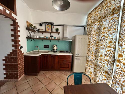 a kitchen with a sink and a refrigerator at B&b Next Stop Napoli in Naples