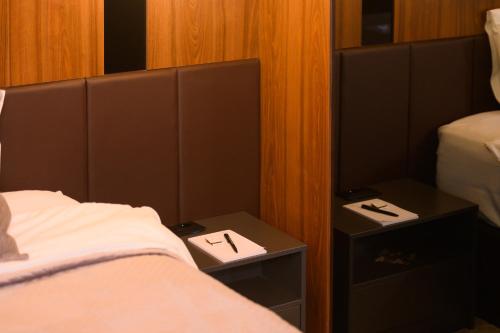 a bedroom with a bed and two night stands at Hotel Macedonia Square in Skopje