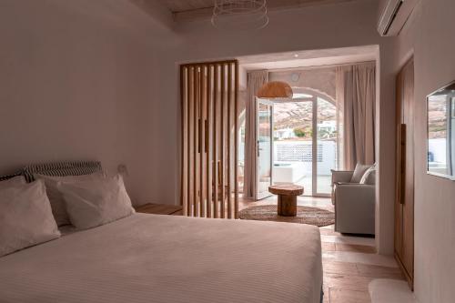 a bedroom with a bed and a living room at Senses Luxury Suites & Villas in Elia Beach