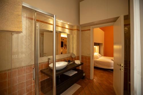 a bathroom with a sink and a shower and a bed at Indipendent Studio Apartment with Terrace - Parking in Florence
