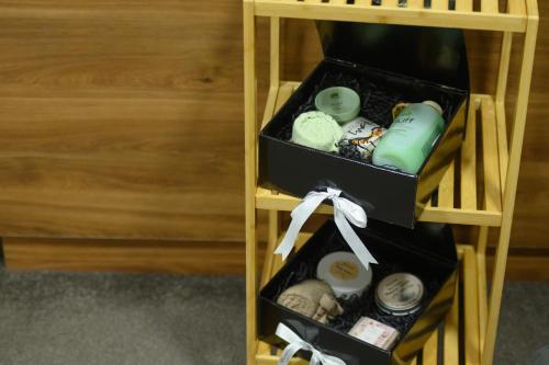 a wooden shelf with two drawers filled with soap at Hotel Macedonia Square in Skopje