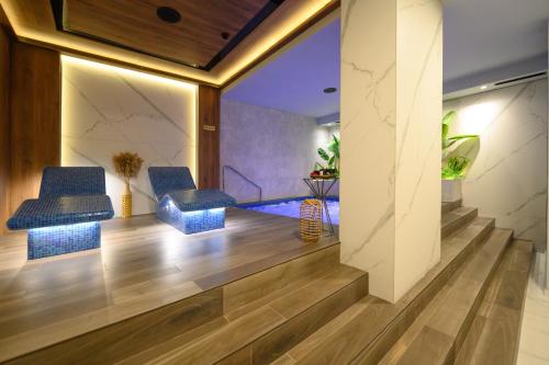 a lobby with blue stools and a swimming pool at Hotel Macedonia Square in Skopje
