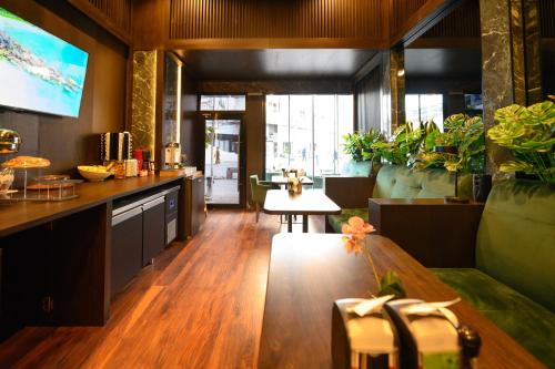 a living room with a table and some plants at Hotel Macedonia Square in Skopje