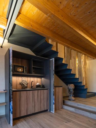 a staircase in a house with wooden ceilings at Il Viaggio Impresa Sociale in Bicchignano