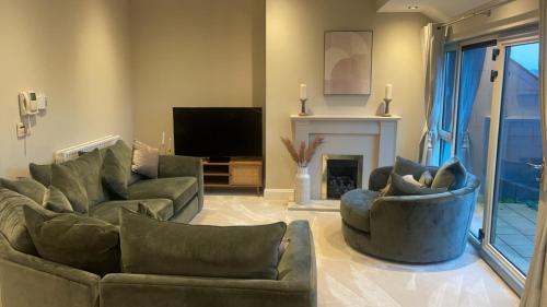 a living room with two couches and a fireplace at Sawgrass Killinard in Killenard