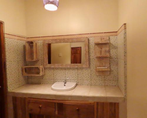 a bathroom with a sink and a mirror at Blue Waves Balangan Homestay in Uluwatu