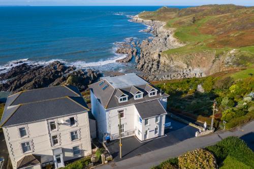 an aerial view of a house and the ocean at Lundy House Hotel in Woolacombe
