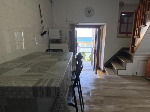 a room with a table and a view of the ocean at La casina de La Fragua in Lastres