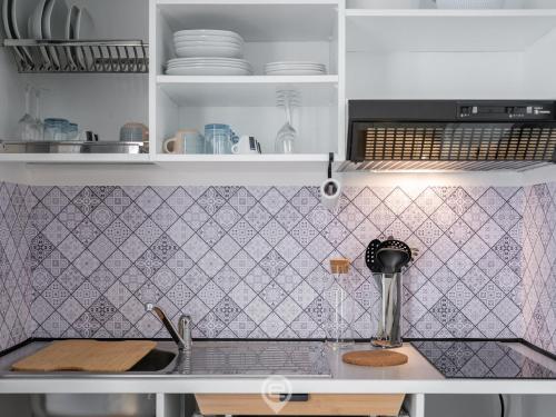 a kitchen with a sink and a counter top at Casa Oskar in Is Molas 