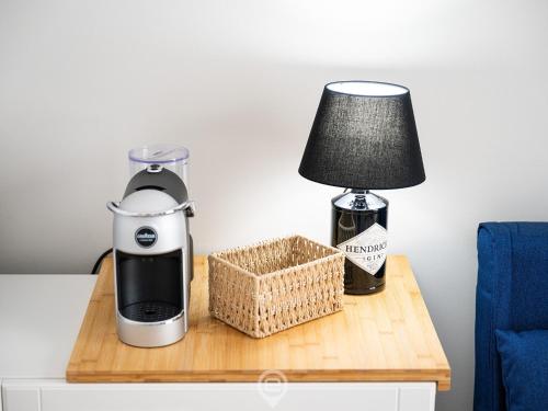 a coffee maker and a lamp on a table at Casa Oskar in Is Molas 