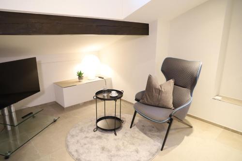 a living room with a chair and a television at Casa QUATTRO FIUMI in Tegna