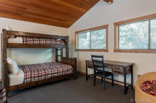 a bedroom with two bunk beds and a desk at 93 Big Prairie in Whitefish