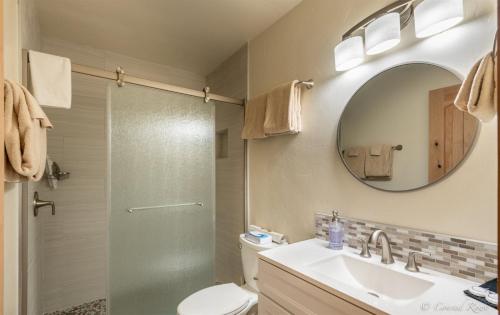 a bathroom with a shower and a sink and a mirror at 93 Big Prairie in Whitefish