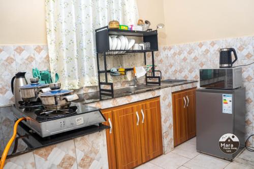 a kitchen with a stove and a counter top at Mara Home Away in Lira, Uganda in Lira