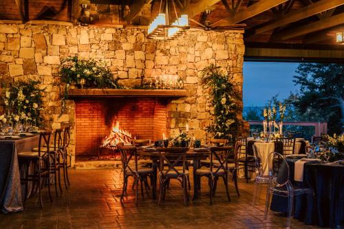 a room with tables and chairs and a fireplace at Cloudland at McLemore Resort Lookout Mountain, Curio Hilton in Rising Fawn