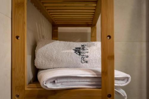a pile of towels sitting in a towel rack at Apartament B3 Green Resort z Basenem, Sauną, Jacuzzi - 5D Apartments in Szklarska Poręba