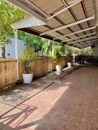 an empty patio with plants in white pots at Qali Home in Olongapo