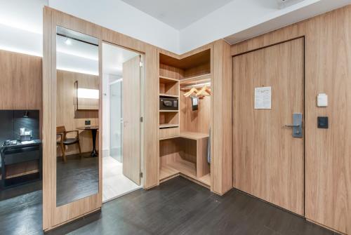 a room with wooden walls and a door and a desk at Radisson São Paulo Paulista in Sao Paulo