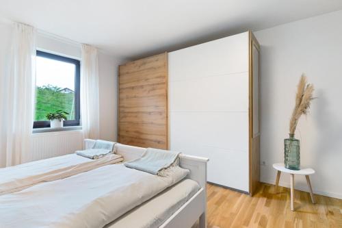 a bedroom with two beds and a window at Ferienwohnung Obsthof Fieß in Oberkirch