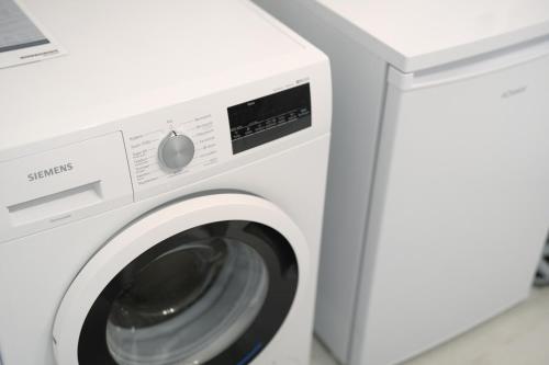 a white washing machine in a room at Ferienwohnung Obsthof Fieß in Oberkirch
