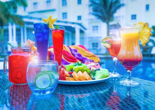 a table with a plate of food and two cocktails at Hemingways Hotel in East London