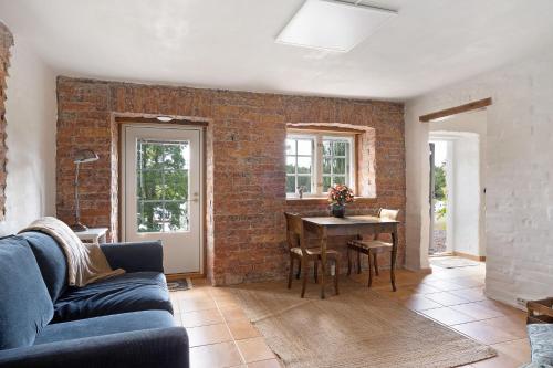 a living room with a brick wall and a table at Villa Wolax in Kaarina