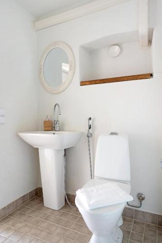 a bathroom with a white toilet and a sink at Villa Wolax in Kaarina