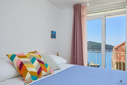 a bedroom with a bed and a large window at Hedera Estate, Hedera A9 in Dubrovnik
