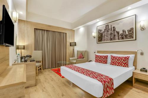 a hotel room with a bed and a television at Lemon Tree Premier City Center in Gurgaon