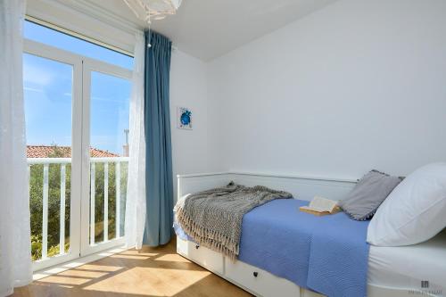 a bedroom with a bed and a large window at Hedera Estate, Hedera A9 in Dubrovnik