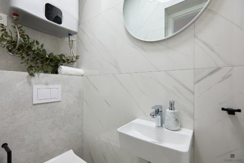 a white bathroom with a sink and a mirror at Hedera Estate, Hedera A9 in Dubrovnik