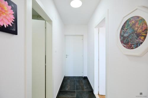 a hallway with white walls and a painting on the wall at Hedera Estate, Hedera A9 in Dubrovnik