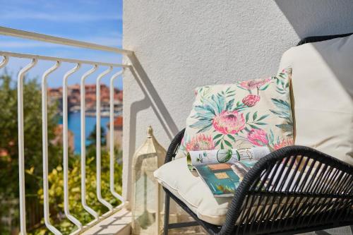 a pillow sitting on a chair on a balcony at Hedera Estate, Hedera A9 in Dubrovnik