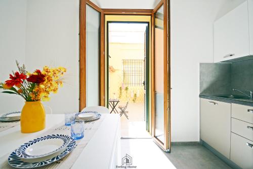 a kitchen with a table with plates and a vase of flowers at Martha's in Follonica