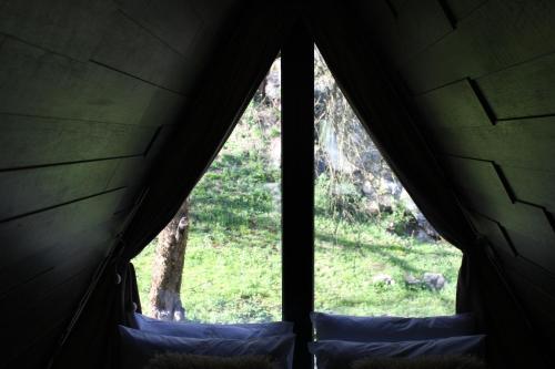 a view from inside a tent looking out the window at Valea Mosului - Cozy A Frame in Petroşani