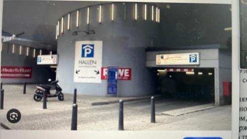 a parking garage with a parking lot with a parking meter at Appartement am Tegeler See in Berlin