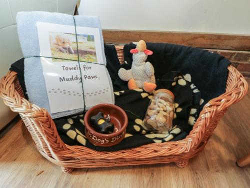 a basket filled with toys and books on a floor at The Old Byre in Salisbury