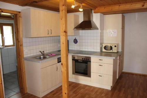 a kitchen with a sink and a stove top oven at Äckerhof in Wolfach
