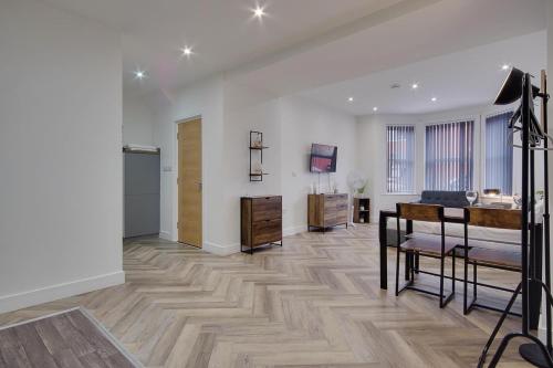 a large living room with a desk and a television at Ashley Road Apartment 1 in Poole