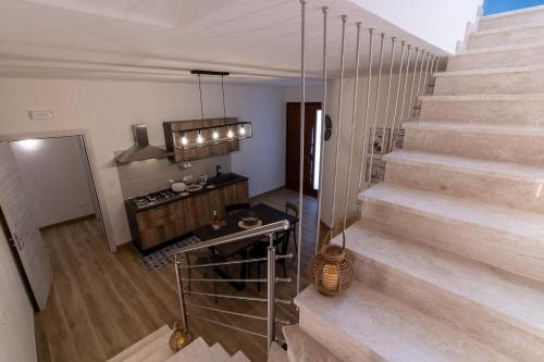 a room with stairs and a kitchen with a table at Baglio Tuzza in Marsala