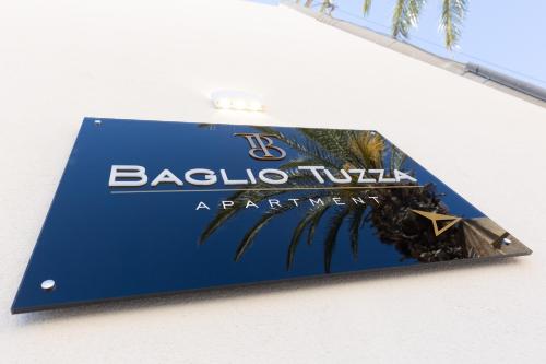 a blue sign with the name of a resort at Baglio Tuzza in Marsala