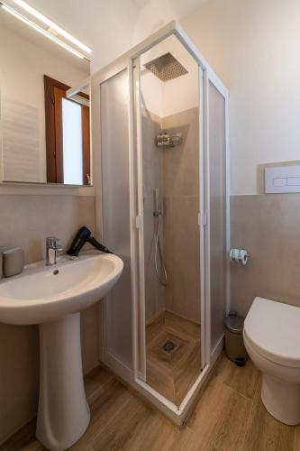 a bathroom with a shower and a sink and a toilet at Baglio Tuzza in Marsala