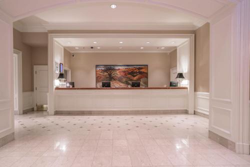 a large lobby with a large painting on the wall at La Grande Residence at the Sutton Place Hotel in Vancouver