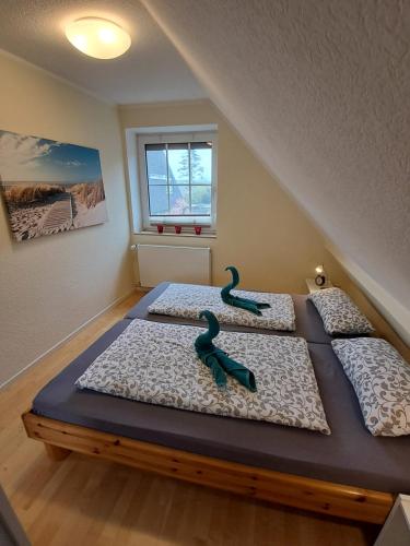 three beds in a room with two at FeWo Nordsee Whng 3 in Wangerland