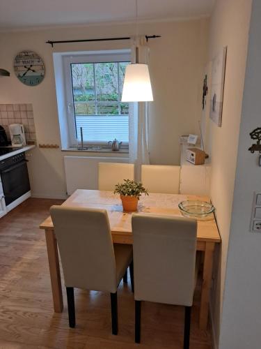 a dining room table and chairs in a kitchen at FeWo Nordsee Whng 3 in Wangerland