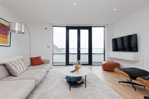 a living room with a couch and a table at Gorgeous 2 Bed Apartment with Stunning Sea Views with Free Parking and Fast Internet in Ramsgate