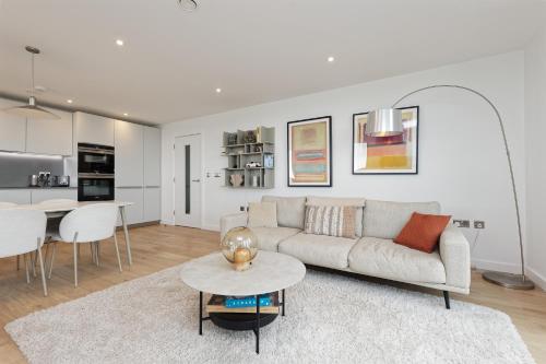 a living room with a couch and a table at Gorgeous 2 Bed Apartment with Stunning Sea Views with Free Parking and Fast Internet in Ramsgate